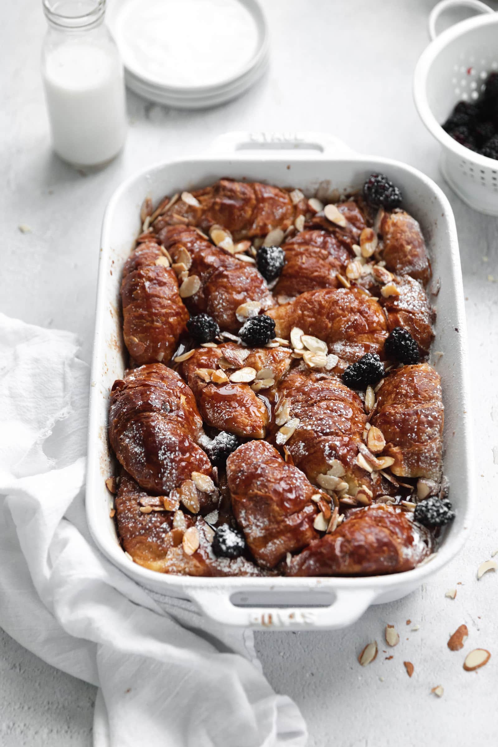 almond croissant french toast with powdered sugar and berries