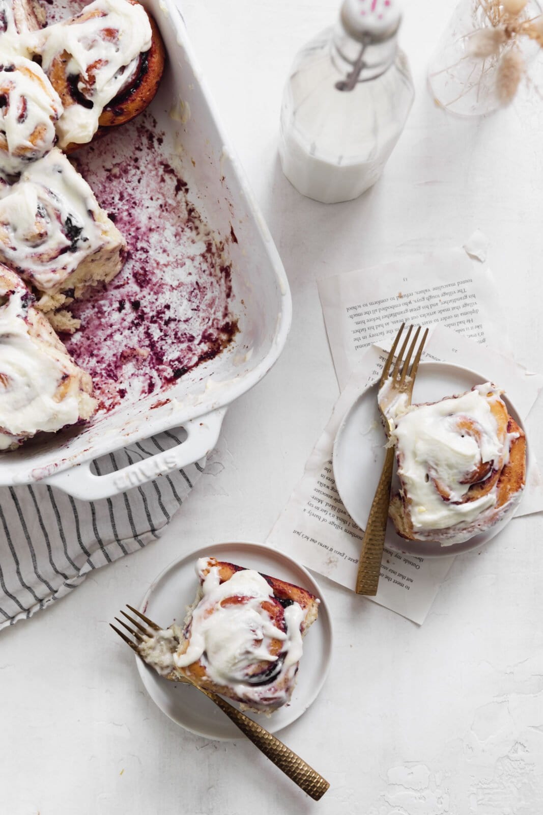 blueberry cinnamon rolls in a white pan