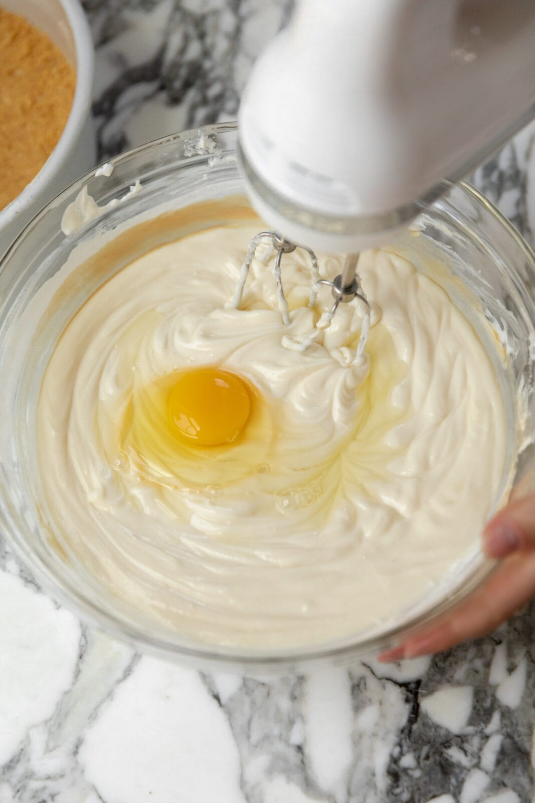 eggs beating into cheesecake batter