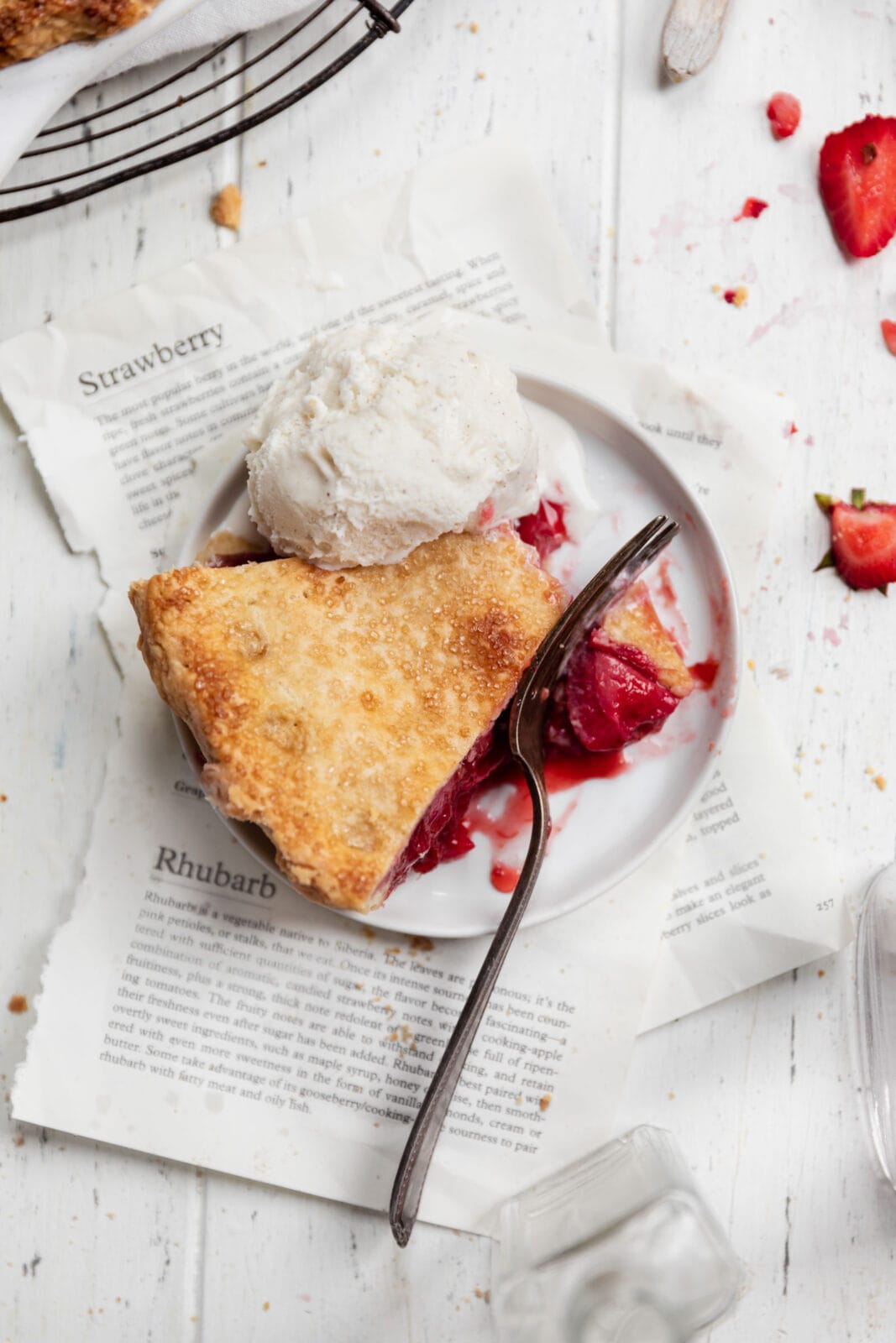 slice of strawberry rhubarb pie with ice cream