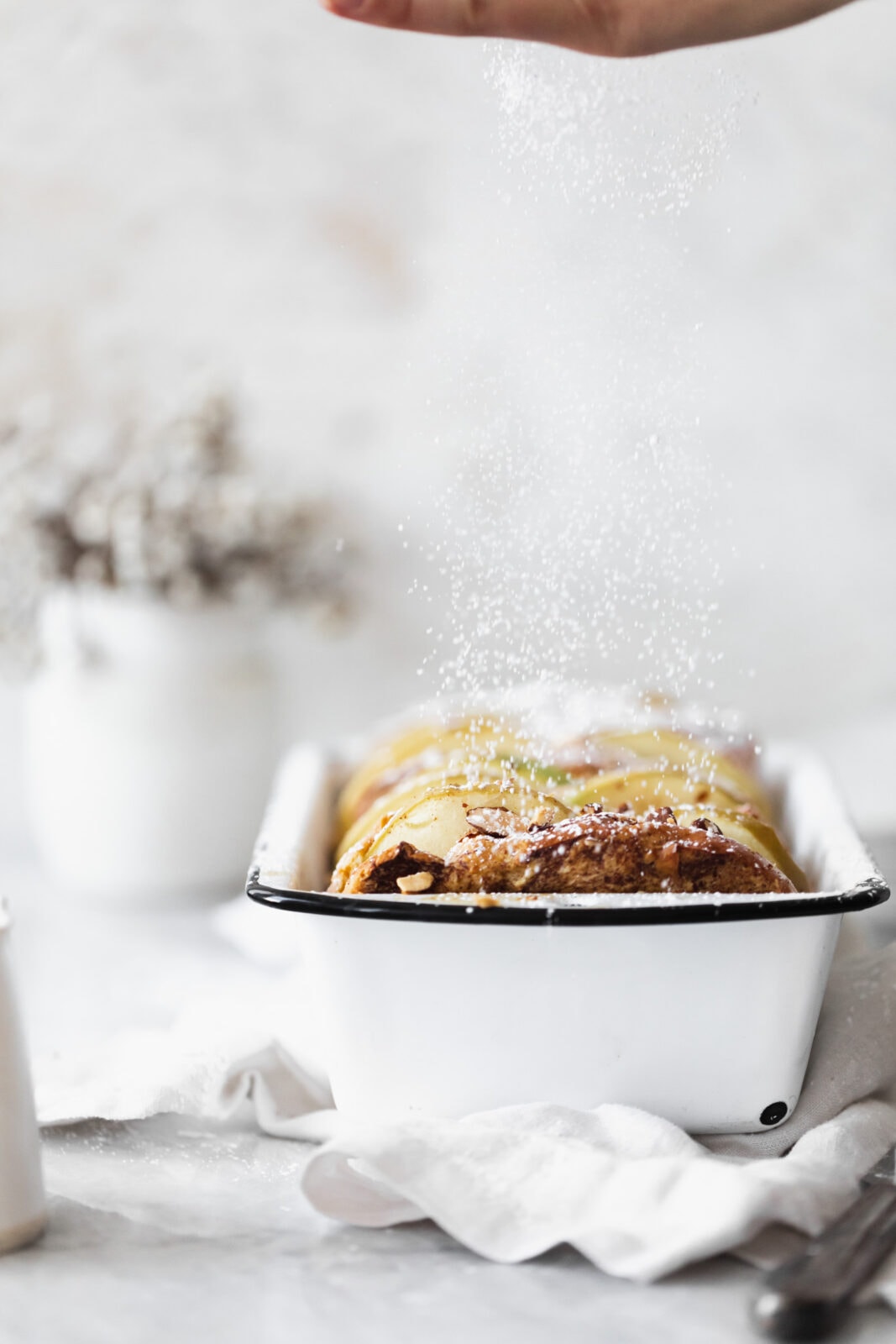 cinnamon apple french toast bake with powdered sugar