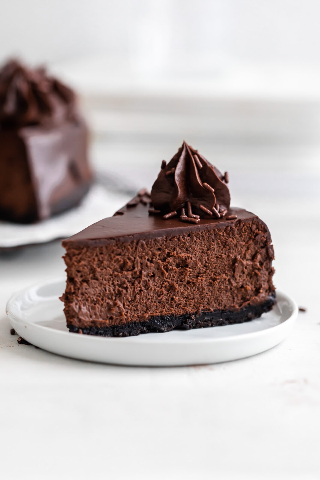 triple chocolate cheesecake with oreo crust and ganache