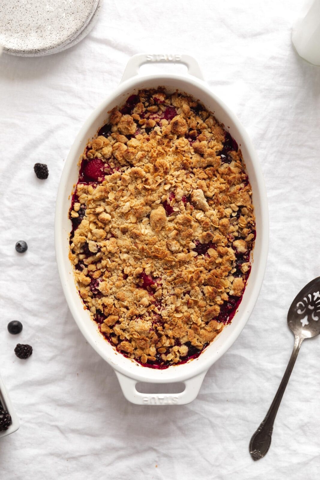 mixed berry crisp in a white baking dish