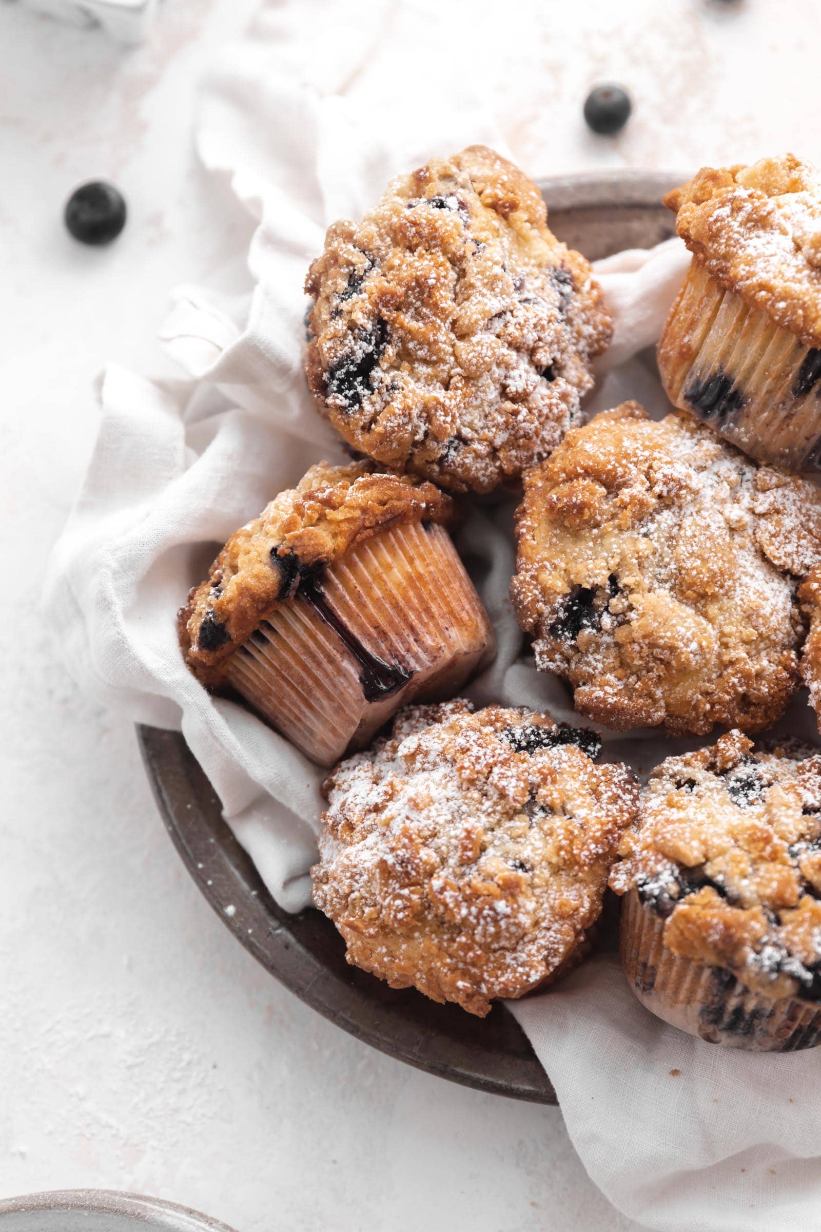 blueberry streusel muffins in a basket