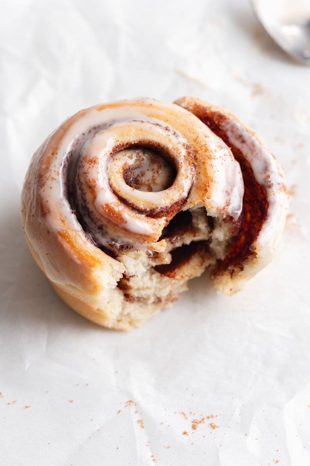 single serve cinnamon roll with a bite taken out to show the fluffy texture