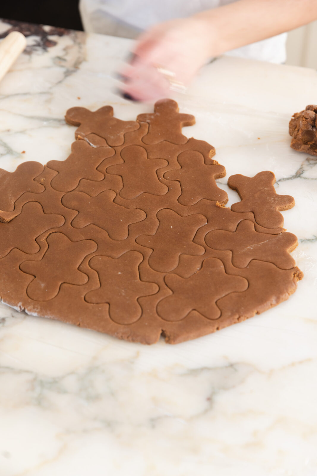 peeling away gingerbread cookie dough