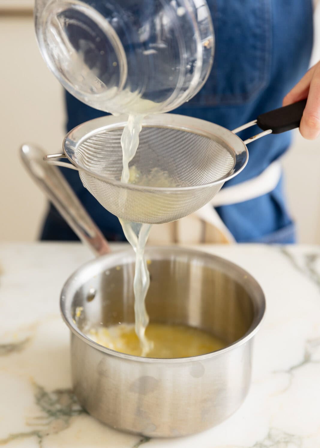 straining lemon juice